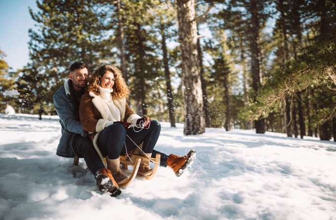 Couple sledding in Solang Valley